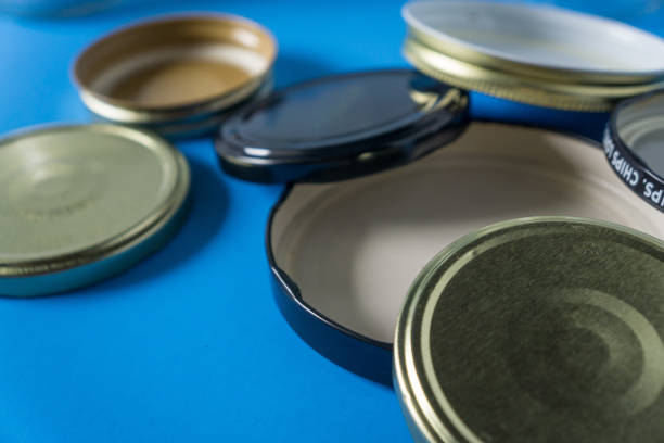 istock Recycling glass jar lids for reuse of single use items; Zero no waste recycle program campaigns; Recyclable concept on blank empty copyspace, text room space for copy on horizontal blue background. 1220181361