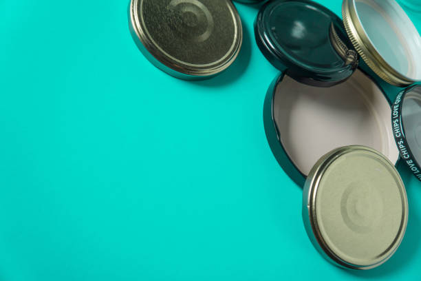 istock Recycling glass jar lids for reuse of single use items; Zero no waste recycle program campaigns; Recyclable concept on blank empty copyspace, text room space for copy on horizontal cyan background. 1220181407