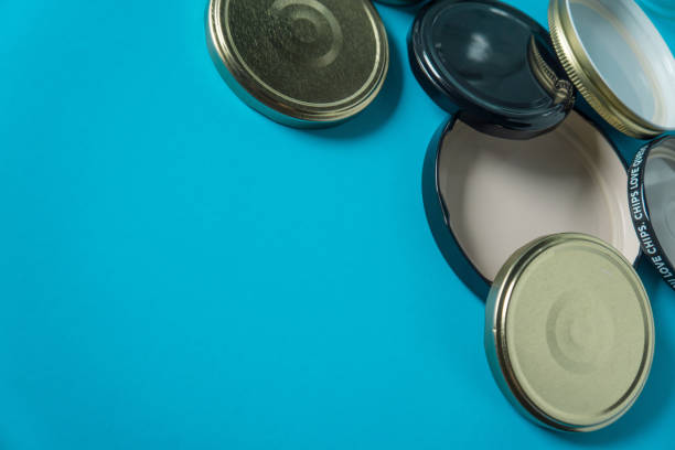 istock Recycling glass jar lids; Reuse of single use items; Zero no waste recycle program campaigns; Recyclable concept on blank empty copyspace, text room space for copy on horizontal light blue background. 1220181438