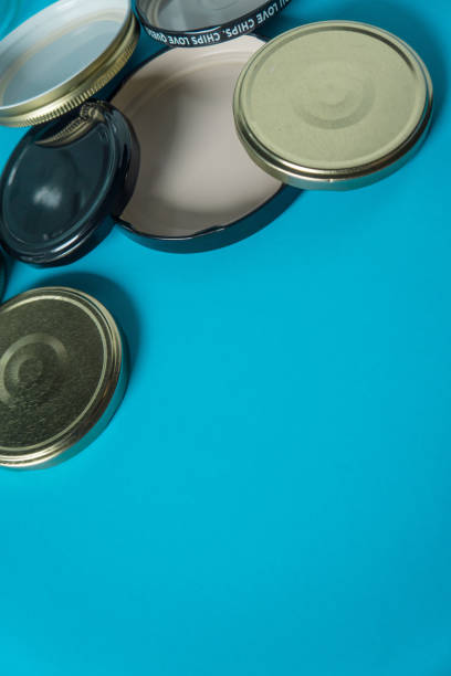 istock Recycling glass jar lids; Reuse of single use items; Zero no waste recycle program campaigns; Recyclable concept on blank empty copyspace, text room space for copy on vertical light blue background. 1220181439