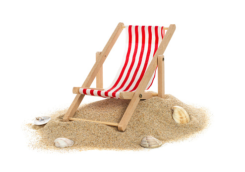 Striped beach chair on sand isolated on white background