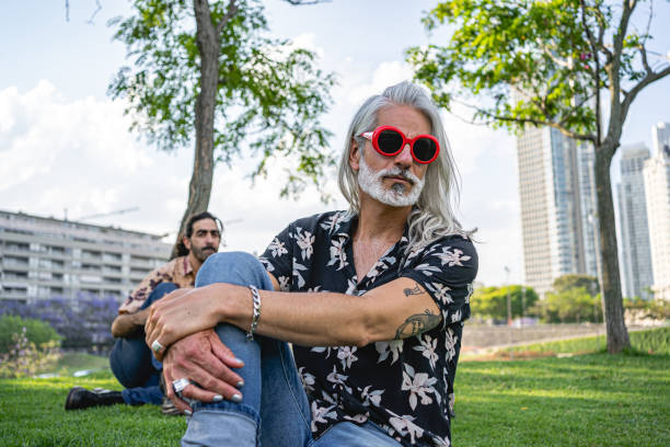 istock Two men sitting in a park together, relaxing 1220182877