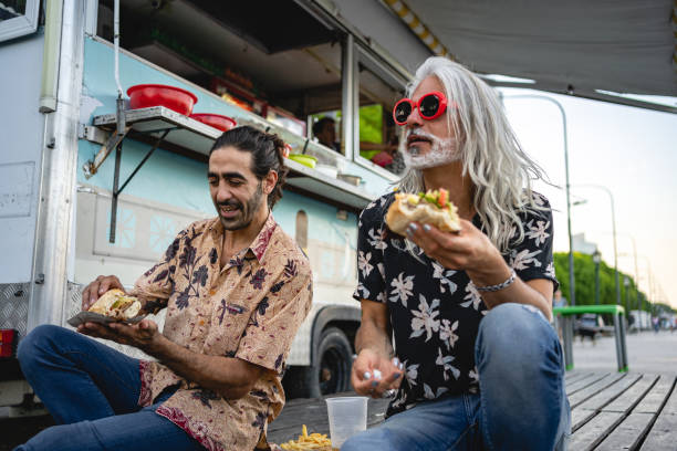 istock Adult tourists enjoying a burger 1220182885