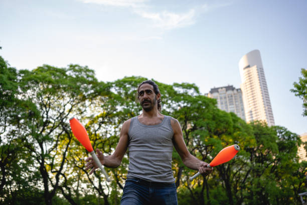 istock Man practicing his juggling skills in a park 1220182900