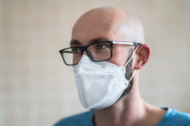 Man With Face Mask Closeup of man with face mask, concept of viral infection (Coronavirus epidemic). kn95 face mask photos stock pictures, royalty-free photos & images
