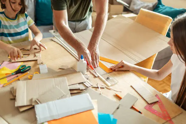 Photo of Father and his children making 3d models at home