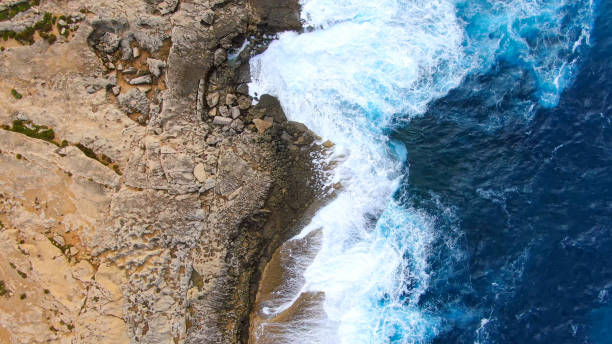 istock Wild Ocean water from above - Waves hitting the rocks 1220185571