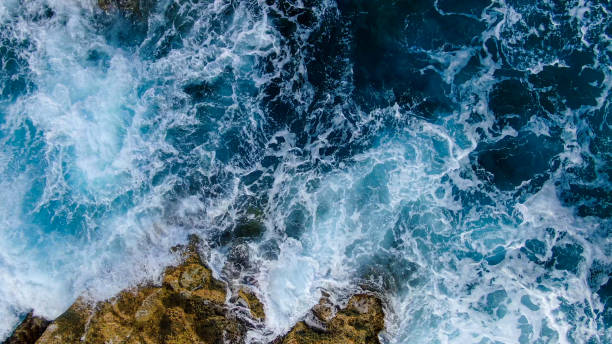istock Wild Ocean water from above - Waves hitting the rocks 1220186143