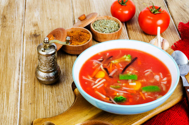 istock Spicy soup with tomatoes on wooden table 1220186612