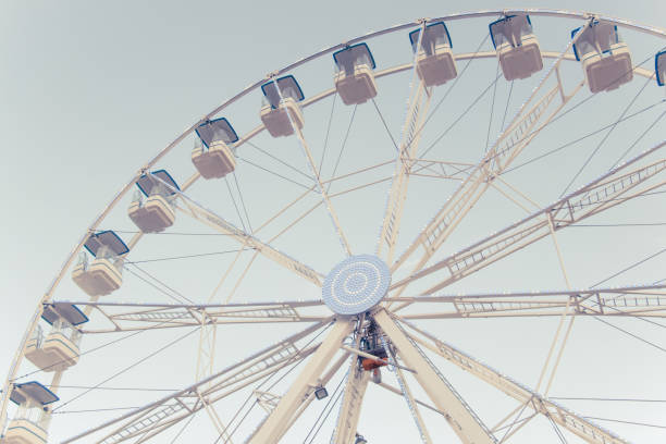 istock A part of ferris and blue sky. Beatiful background with ferris. Blue, light, white, sky, ferris wheel. Ferris wheel and piece sunlight. Vintage style. 1220188025