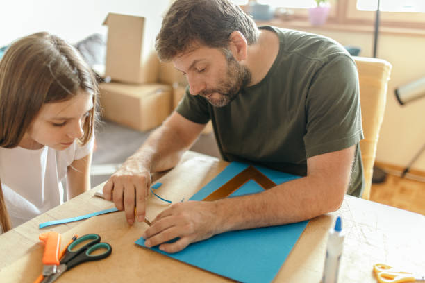 istock Father and his daughter making 3d models at home 1220188800