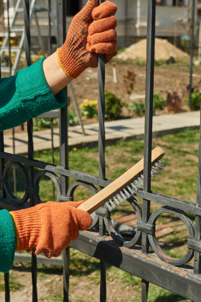 istock the master cleans the metal fence 1220189163