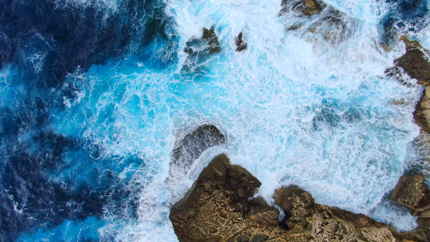 istock Wild Ocean water from above - Waves hitting the rocks 1220191059
