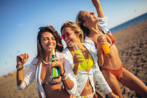 istock Group of three beautiful attractive young women having fun on the beach. 1220191836