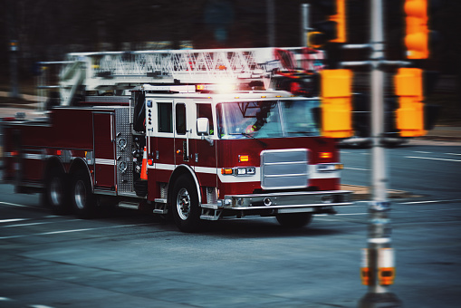 A firetruck speeds through an intersection.