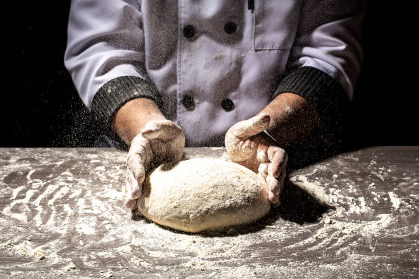 istock pizza prepare dough hand topping. chef prepares the dough with flour 1220192754