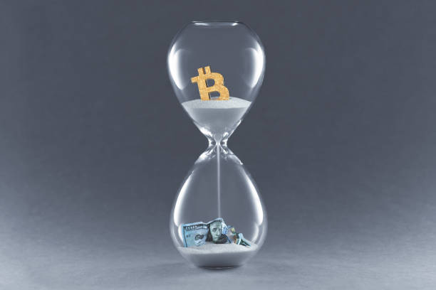 istock Hourglass on dark background. Concept passing traditional currency time, and time cryptocurrency Bitcoin and blockchain technology 1220192772