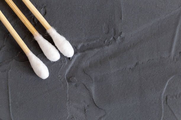 Bamboo cotton sticks for medicine, cosmetics, ear cleaning on a gray background. Concept of an eco-friendly lifestyle. Toning. Selective focus.