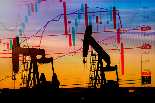 Explicit Illustration depicting the historic fall in the price of oil with an oil well in silhouette in the background