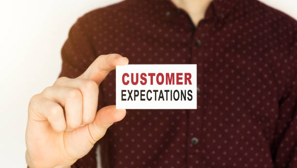 istock Businessman holding a card with text Customer Expectations. 1220194727
