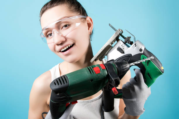 istock Smiling woman and power tools - electric drill and jigsaw 1220195591