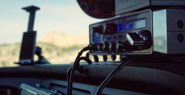 A CB Radio Sits on the Console of the Dashboard of a Semi-Truck on a Sunny Day A CB Radio Sits on the Console of the Dashboard of a Semi-Truck on a Sunny Day semi truck audio stock pictures, royalty-free photos & images