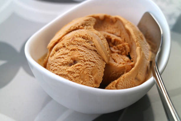 istock Closeup delectable homemade caramel ice cream in a white bowl 1220196252