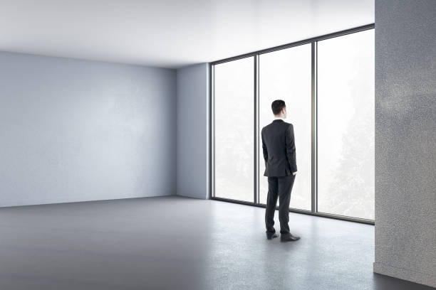 istock Businessman standing in minimalistic interior 1220197056