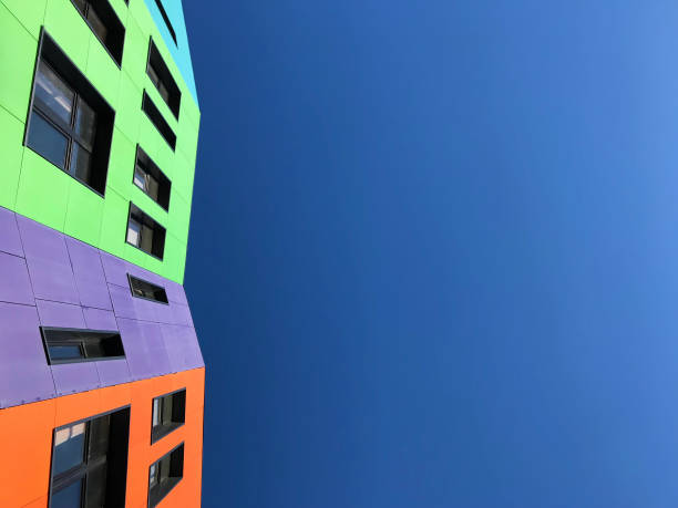 istock Multi-colored bright facades of the school with black window frames. 1220197060