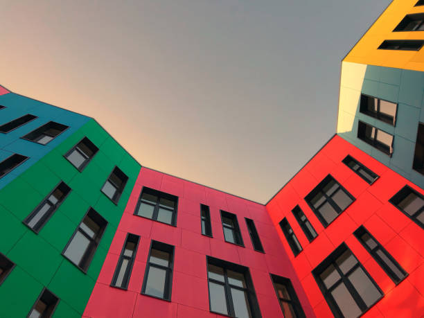istock Multi-colored facades of a modern building with black window frames. 1220197082