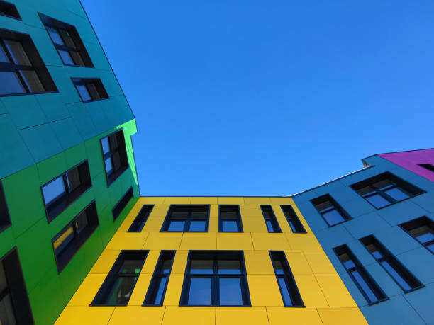 istock Multi-colored bright facades of the school with black window frames. 1220197094