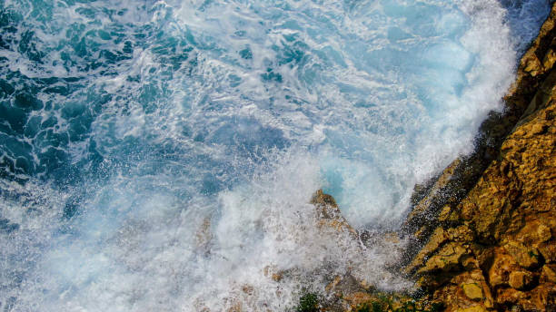 istock Wild Ocean water from above - Waves hitting the rocks 1220197238