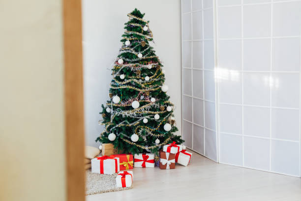 istock Christmas tree gifts winter background holiday new year 1220197630