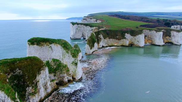 A craggy rock formation is viewed against a clear blue sky in Butter Rock - Dorset - Great Britain