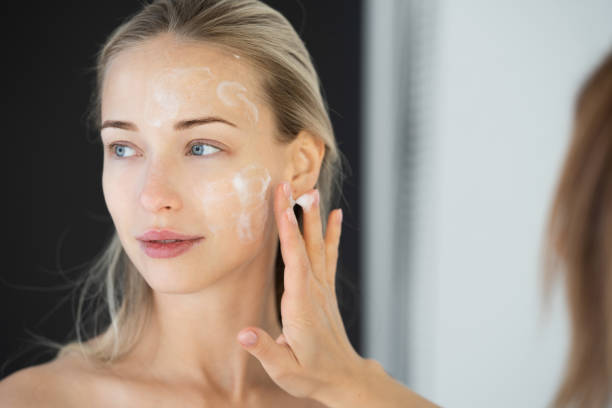 istock Makeup artist working on young female model 1220198663