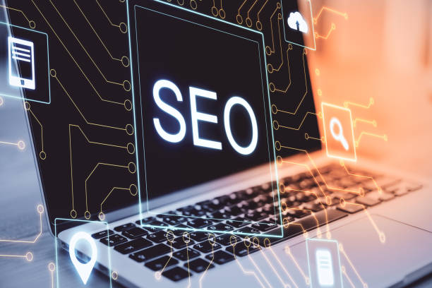 istock Laptop ona table and creative digital SEO hologram. 1220198927