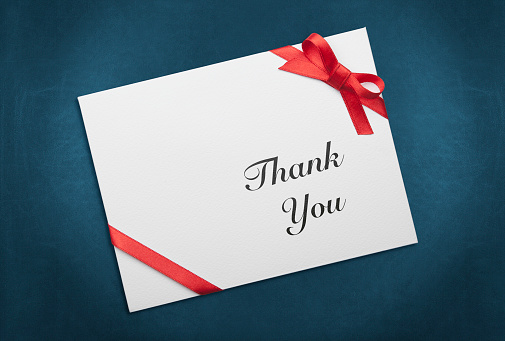 Envelope with Red Ribbon And Thank You Message on Blue Background