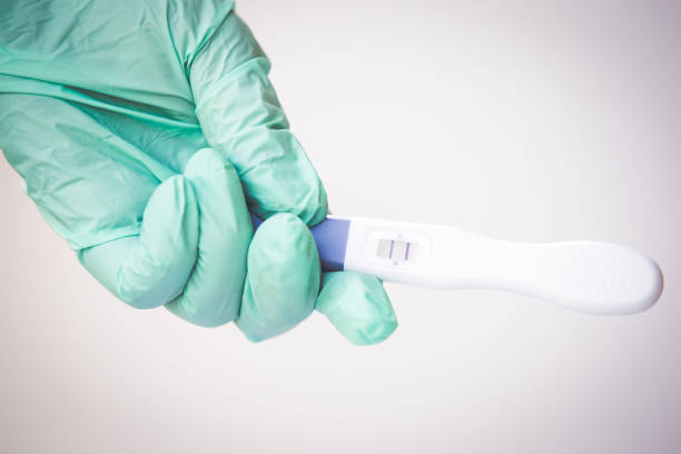 istock Positive pregnancy test in coronavirus pandemic 1220199319