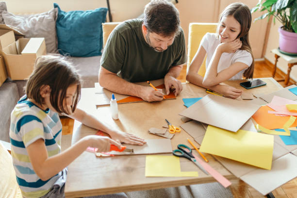 istock Father and his children making 3d models at home 1220201521