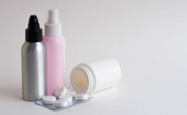 istock Bottles with tablets in white, pink, gray on a gray background. Copy space 1220202445