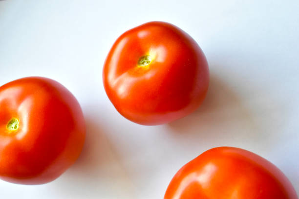 istock Red and juicy tomatoes on a white background 1220204346