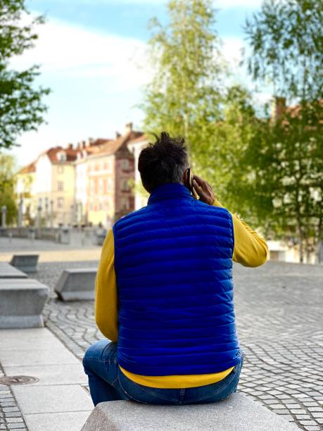 istock Adult man looking down streets talking on the phone 1220205955