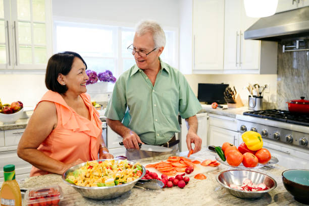 istock Compatible Hispanic senior couple preparing food in kitchen 1220206139