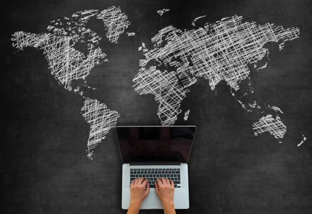 istock Global Business Concept With Laptop On Blackboard 1220209460