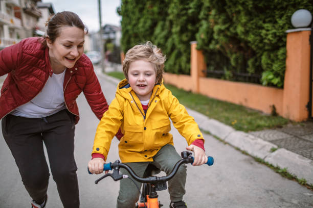istock Mother teaching her son to ride a bicycle 1220210502