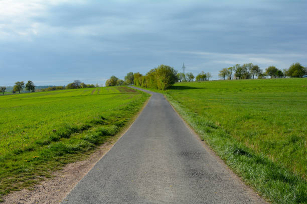 istock A  empty country road between green nature 1220211340