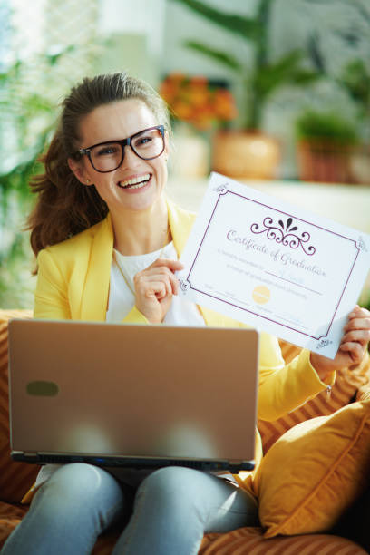 istock learner woman with laptop showing certificate of graduation 1220211993