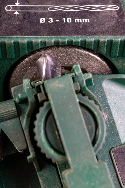 istock Sharpening a metal drill bit. Steel drill sharpened for specialized sharpeners. Dark background. 1220212612