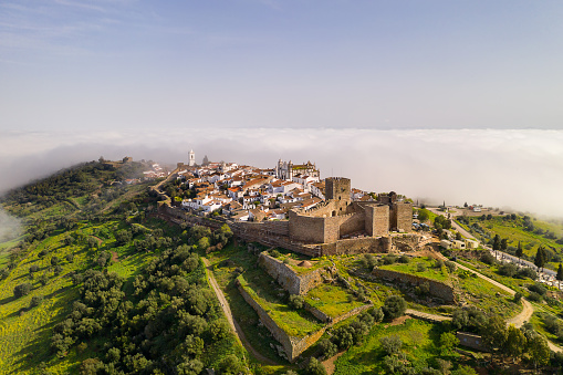 Monsaraz drone aerial view on the clouds in Alentejo, Portugal