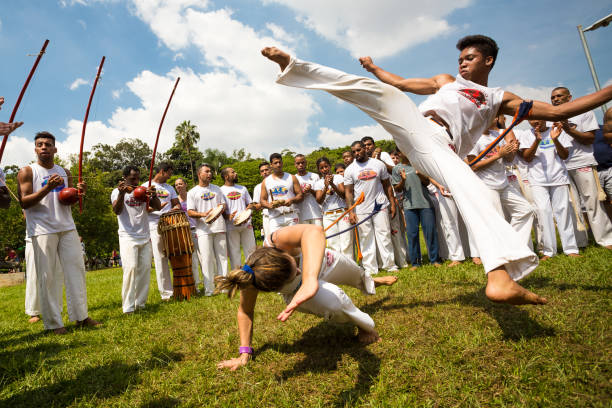 group of brazilian capoeiristas performing at the ibirapuera park in são paulo - são imagens e fotografias de stock
